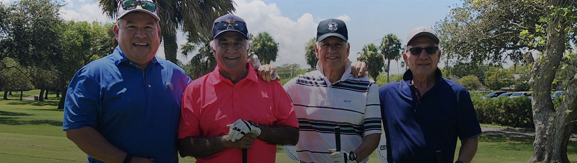 Showing a group of golfers posing for a photo on the green.
