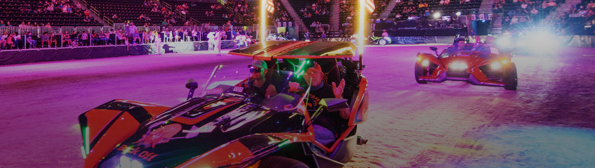 Showing some flashy reverse trike motorcycles driving through the arena during the Night Parade.